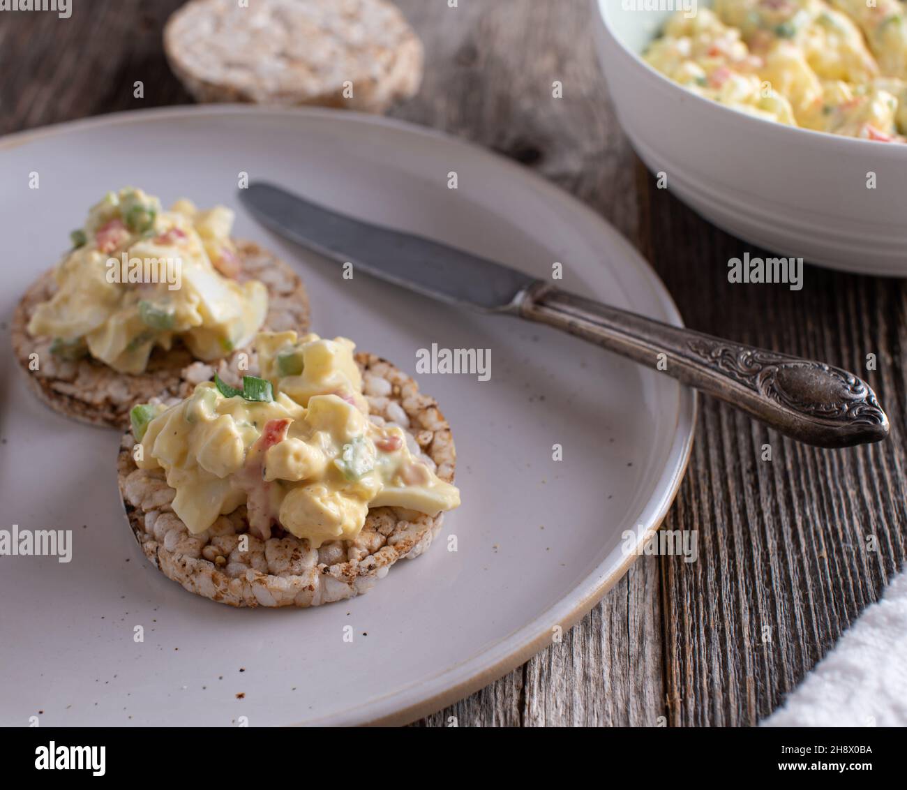 Fitness meal and high protein food with a low fat egg salad served with brown rice cracker on a plate Stock Photo