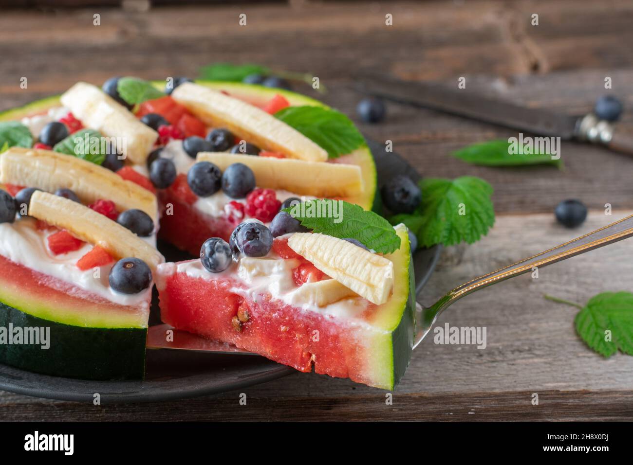 Fitness breakfast or snack for summer season with sliced watermelon, topped with skyr, and fresh fruits Stock Photo