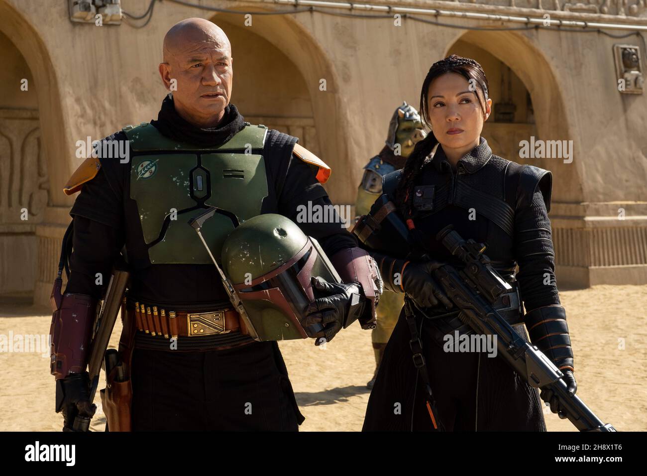 (L-R): Boba Fett (Temura Morrison) and Fennec Shand (Ming-Na Wen) in Lucasfilm's THE BOOK OF BOBA FETT, exclusively on Disney+. Photo credit: Francois Duhamel / Lucasfilm Ltd./ The Hollywood Archive Stock Photo