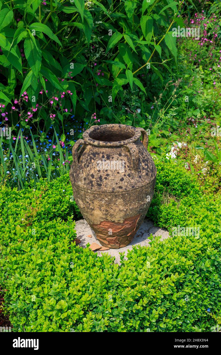 A frost damaged garden urn at Burrow Farm Garden, Devon, England, UK Stock Photo