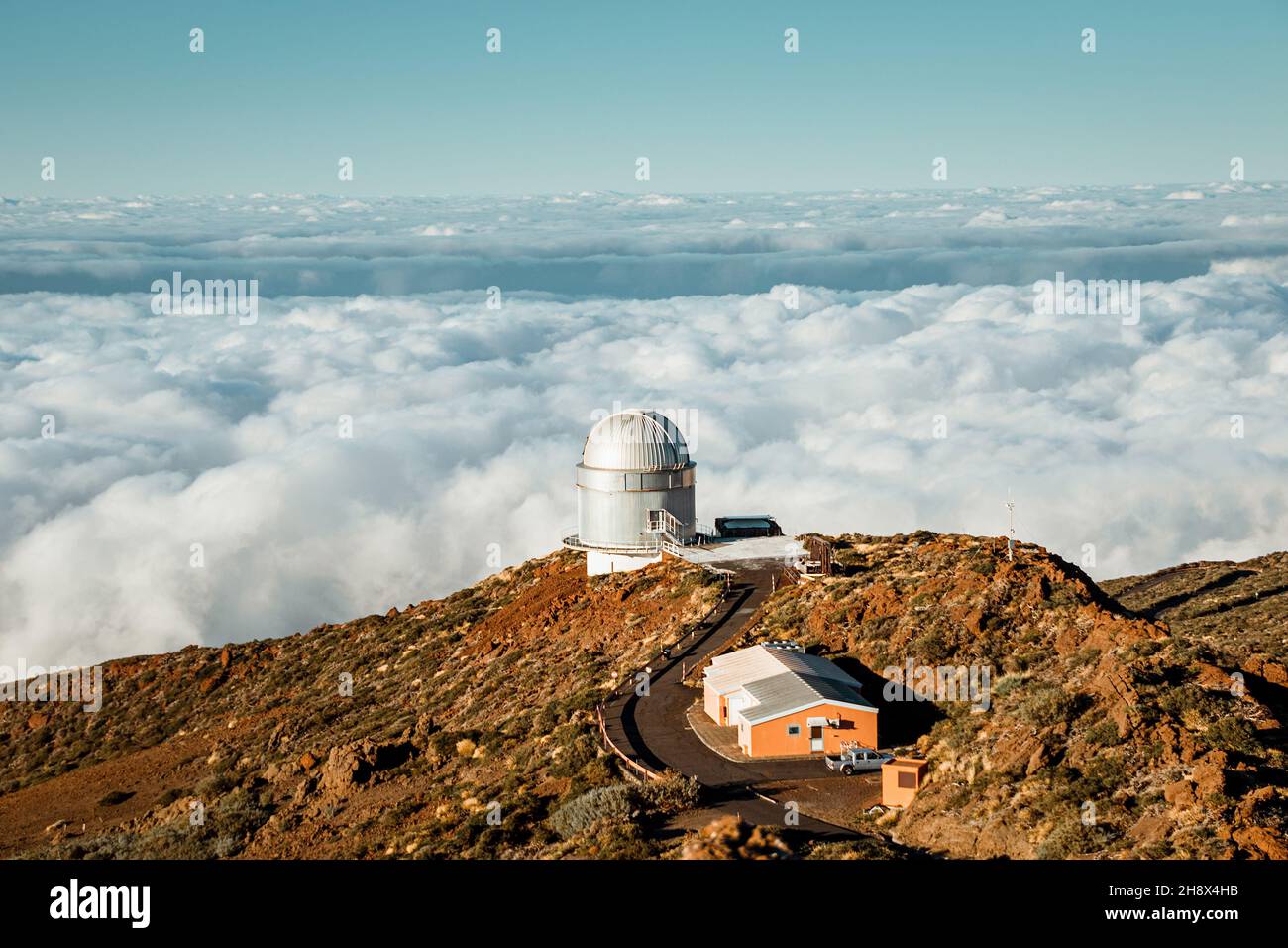 Largest optical reflecting telescope Gran Telescopio Canarias located on  grassy hilltop against cloudy sky at astronomical observatory on island of  La Stock Photo - Alamy