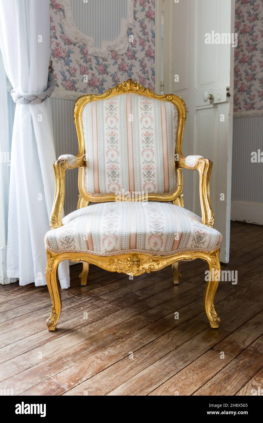Gilded French Rococo armchair located in a chateau in La Loire Stock Photo