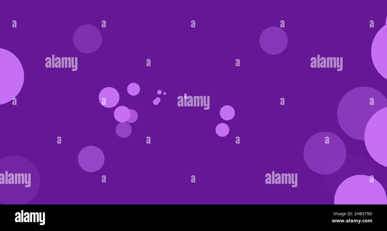Digitally generated image of bokeh effect on purple background with ...