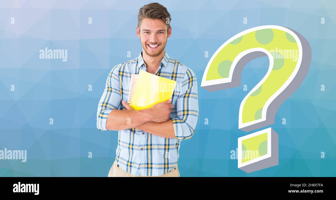Portrait of smiling young man holding books by question mark over blue background Stock Photo