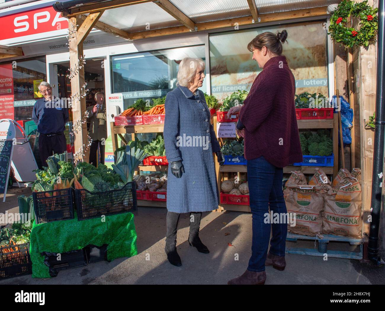 The Duchess of Cornwall meets with Hannah Paget, local farmer and vegetable supplier, during a visit to independent Spar shop owner Derek Tinnion at his store in Devizes, Wilsthire, to thank him and his family and staff for their tireless work in supporting the Devizes community for over 60 years, especially during the pandemic. Picture date: Thursday December 2, 2021. Stock Photo