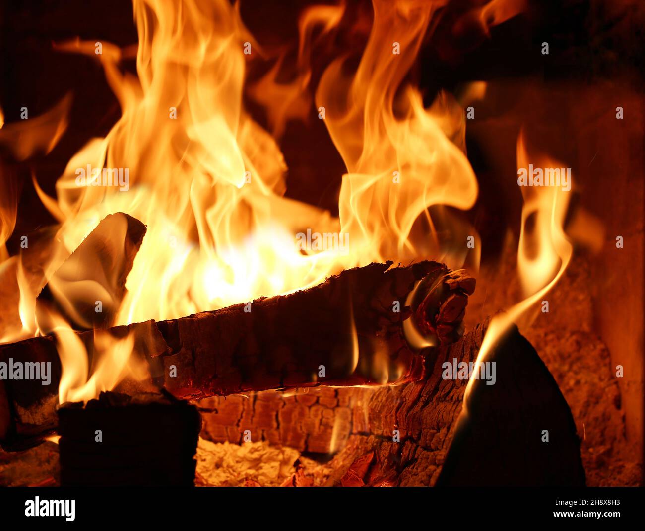Open flames in the tiled stove Stock Photo