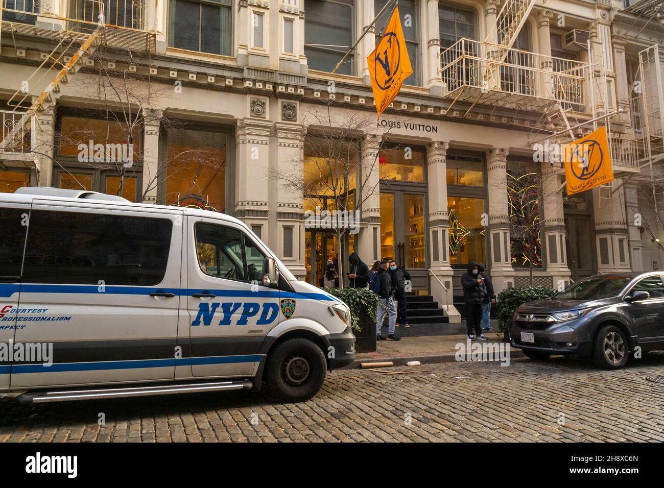 Police in front of the Louis Vuitton store in the Soho neighborhood of New York on Saturday, November 27, 2021 during the Black Friday weekend. The police presence was noticeable as the NYPD pro-actively prevented a smash and grab problem that effected San Francisco. (© Richard B. Levine) Stock Photo