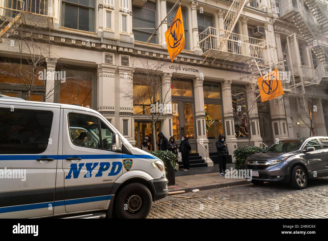 Police in front of the Louis Vuitton store in the Soho neighborhood of New York on Saturday, November 27, 2021 during the Black Friday weekend. The police presence was noticeable as the NYPD pro-actively prevented a smash and grab problem that effected San Francisco. (© Richard B. Levine) Stock Photo