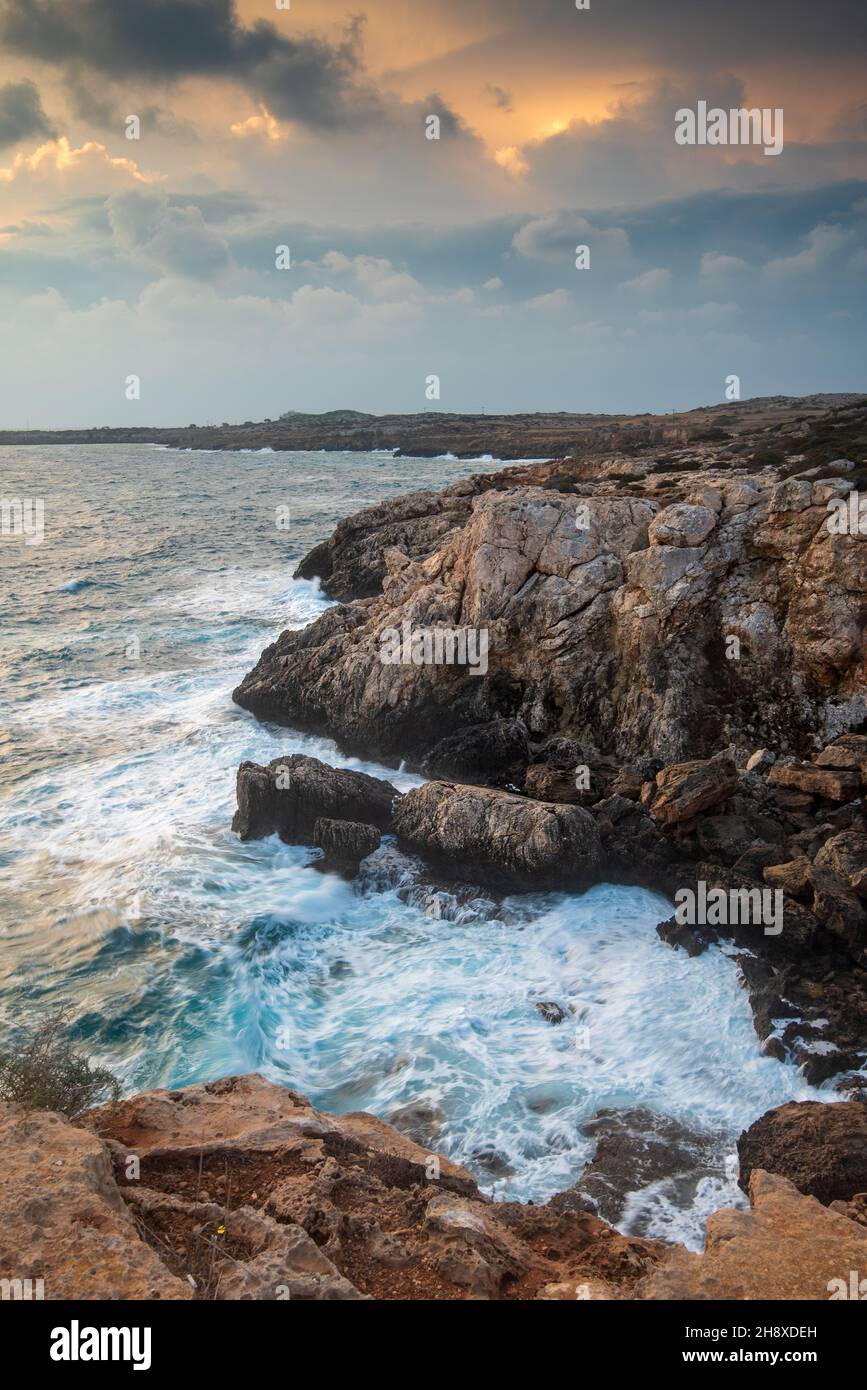 Seascape with windy waves during stormy weather at sunset. Stock Photo
