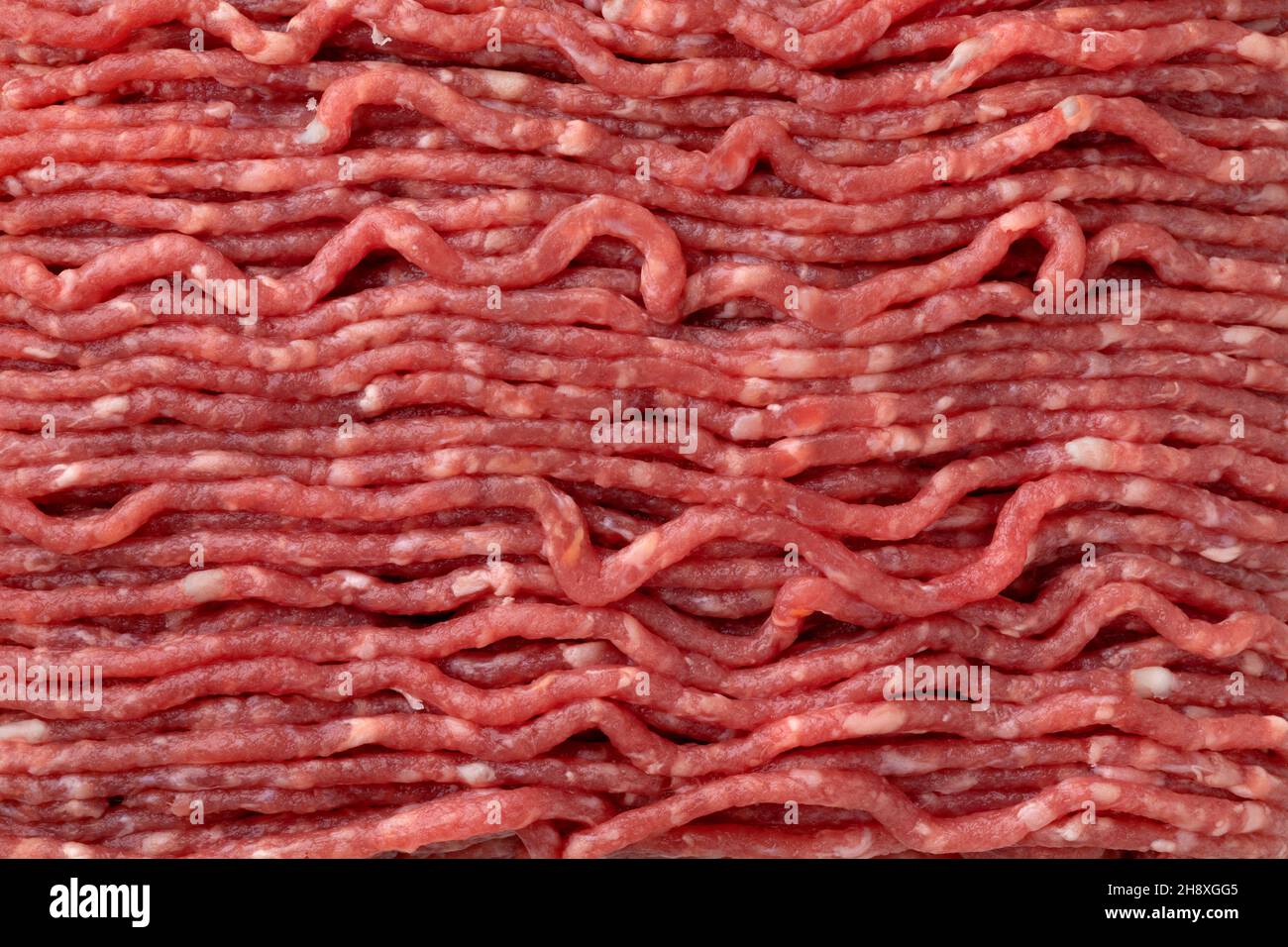 Fresh raw low fat ground beef full frame close up as background Stock Photo