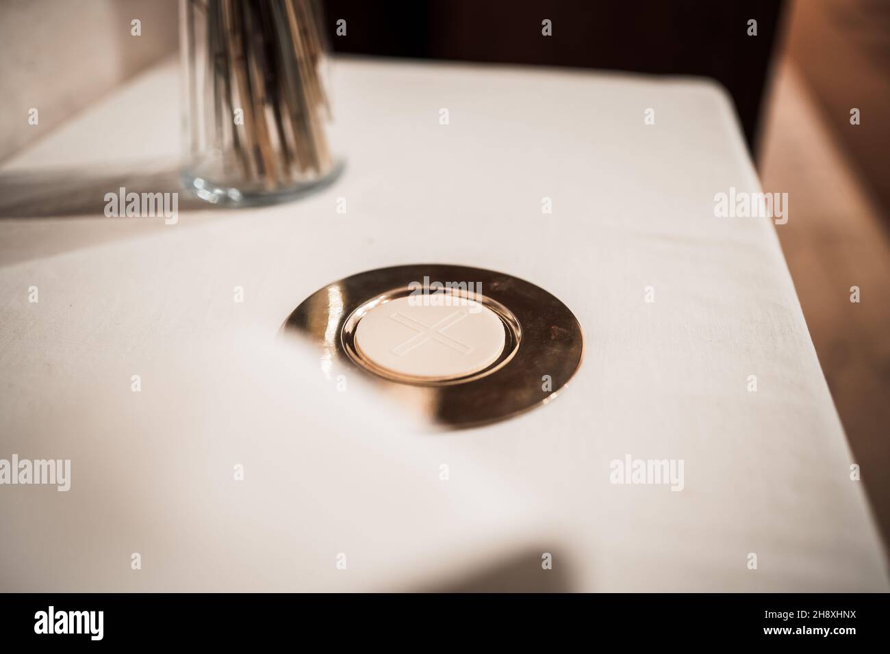 The body of Christ bread on a golden mat in the church Stock Photo