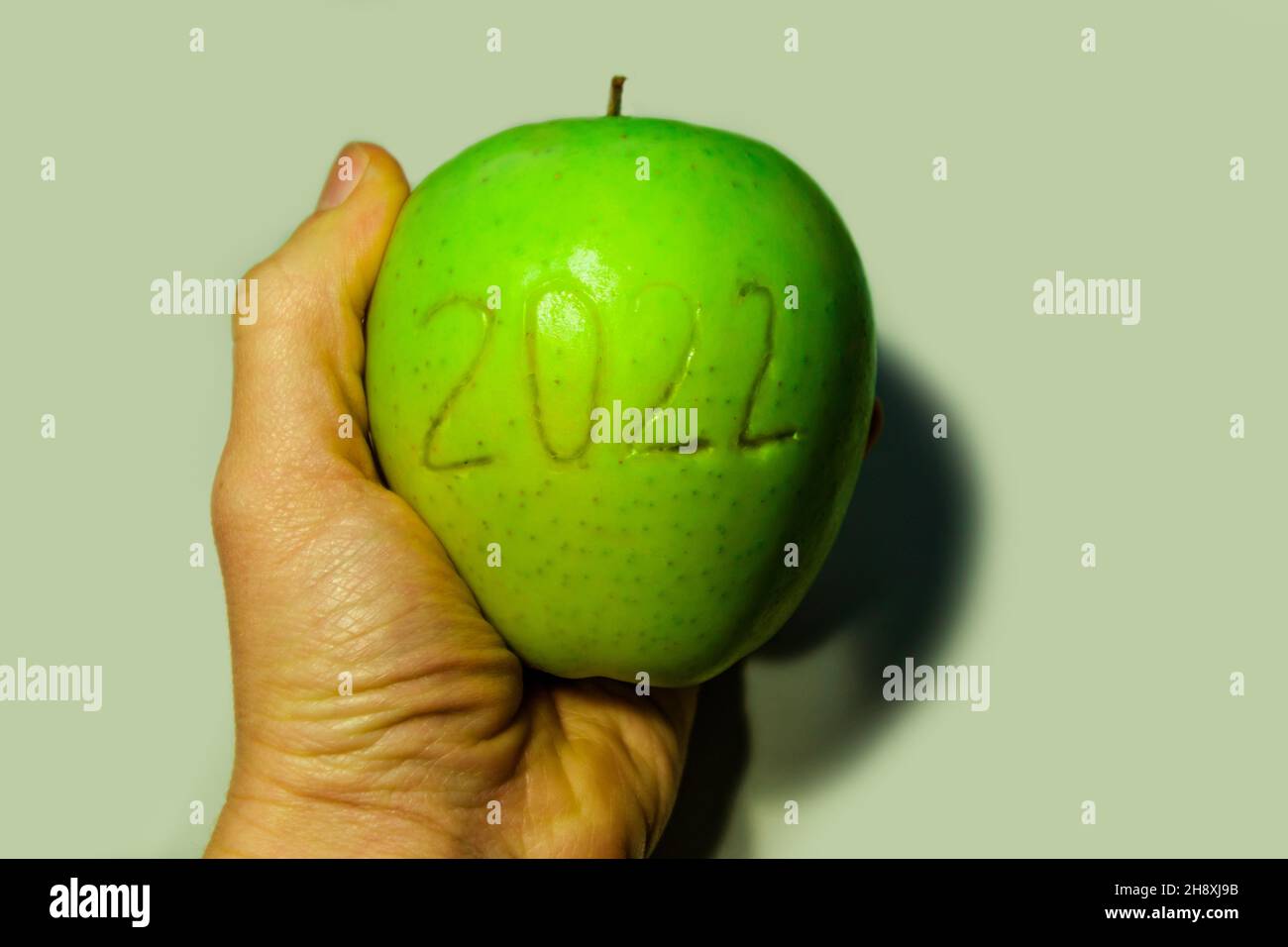 Number 2022, placed on an apple, against a white background.  Stock Photo
