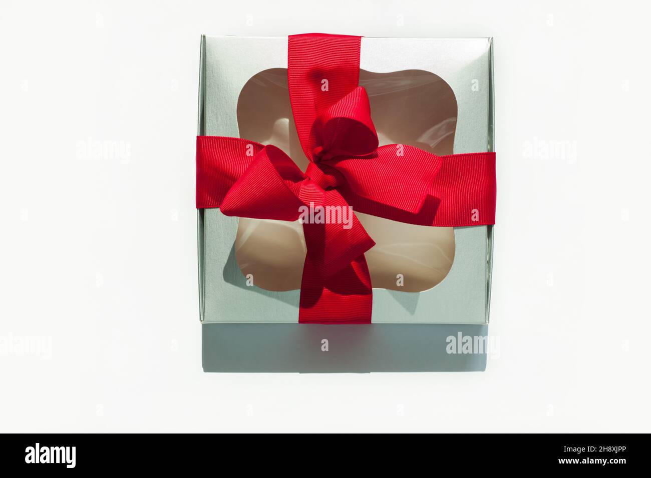 Silver gift box with red ribbon bow isolated on white background ...