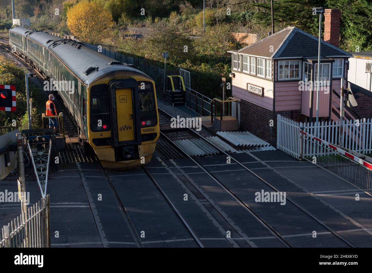 Crediton, Devon, England, UK. 2021. Passenegr train departing Crediton