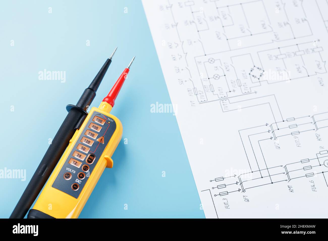 Yellow voltage indicator with an electrical diagram on a blue