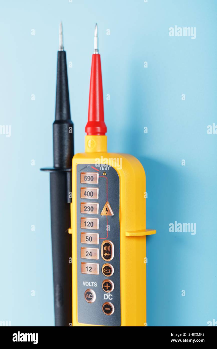 Twopole voltage indicator closeup on a blue background. Testing and