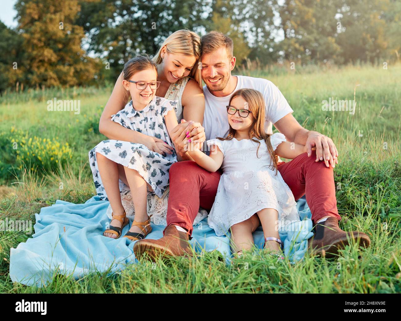 child family portrait outdoor mother woman father girl happy happiness lifestyle having fun bonding Stock Photo