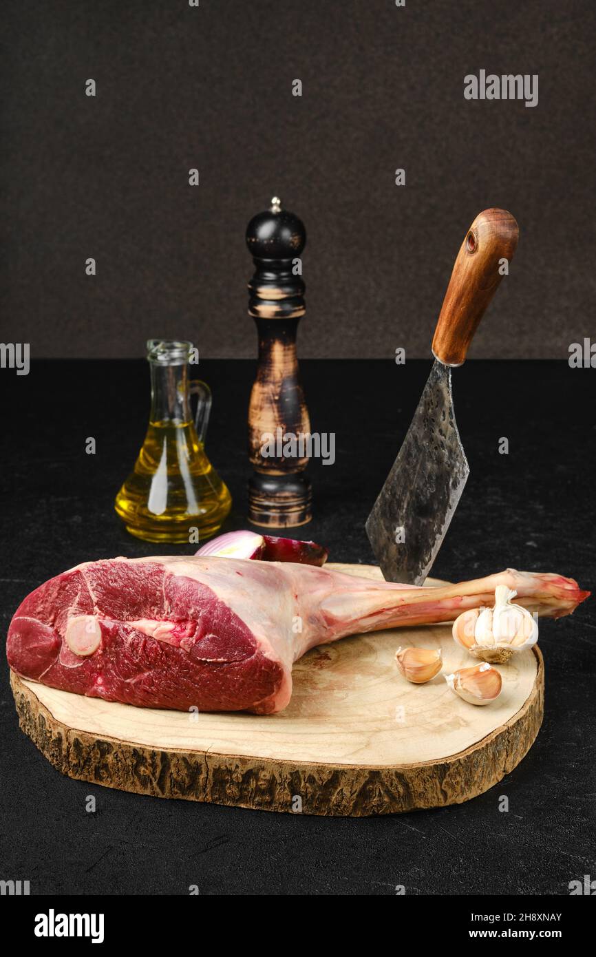 Raw fresh lamb short cut leg, sirloin off on wooden cut log Stock Photo