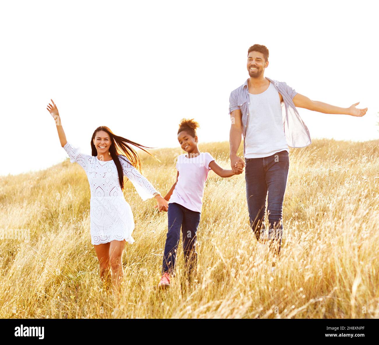 child daughter family happy mother father love fun together girl cheerful field outdoor natur summer Stock Photo