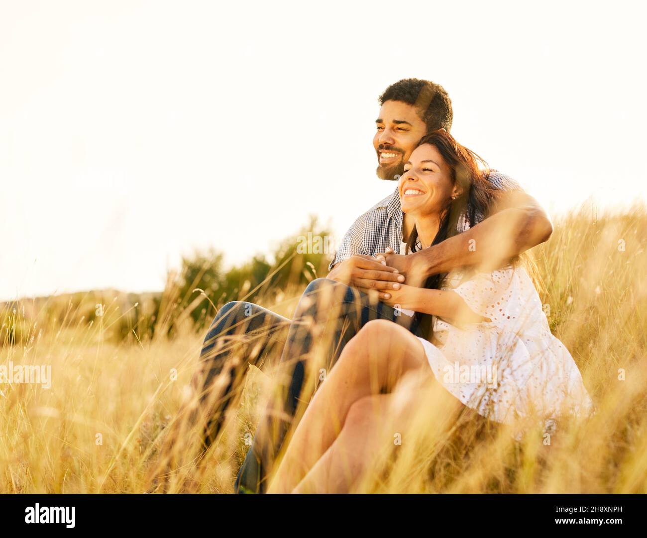 nature woman outdoor couple field love young man summer girl beautiful happy romantic autumn together Stock Photo