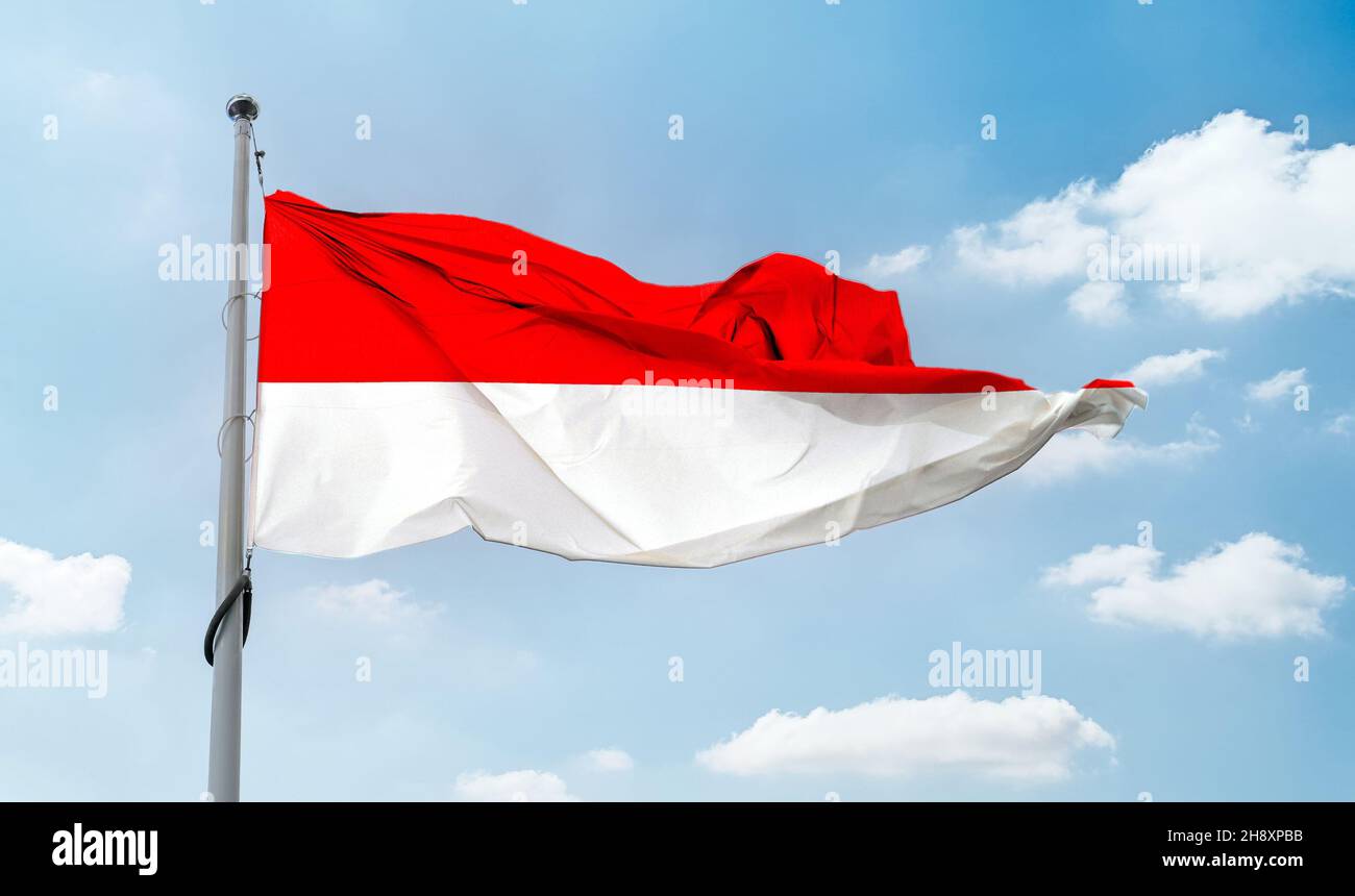 Indonesian flag waving on a pole in a blue sky Stock Photo - Alamy
