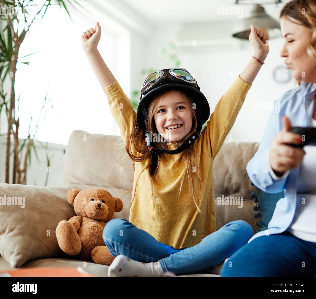 child daughter mother family happy playing console kid childhood joystick cotroller Stock Photo