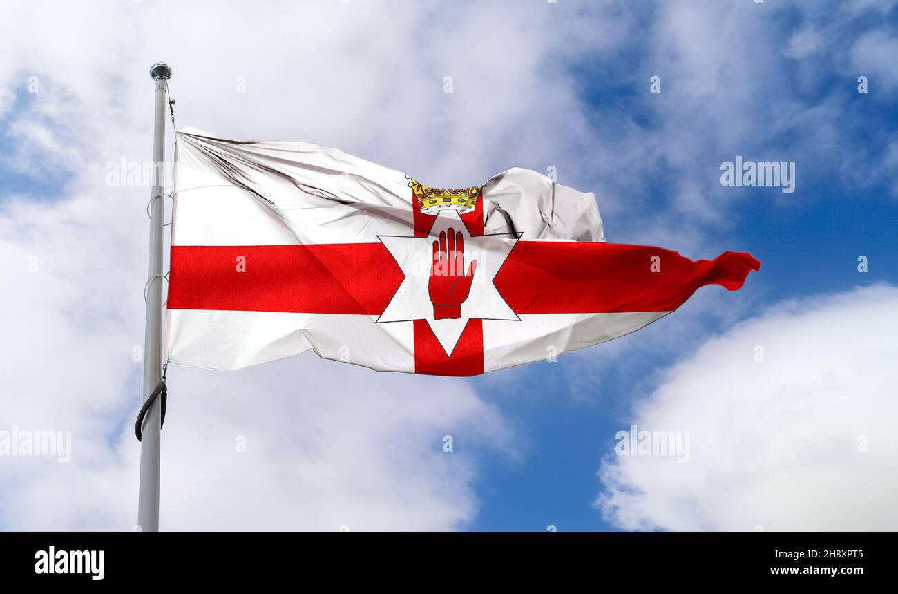 Northern Ireland flag waving on a pole in a blue sky Stock Photo - Alamy