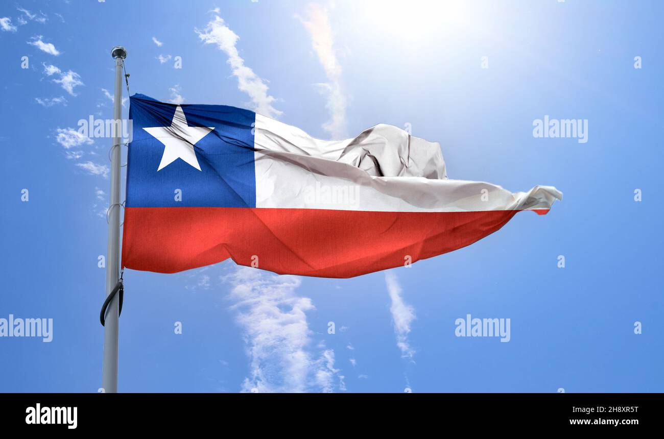 Chile flag waving on a pole in a blue sky Stock Photo Alamy
