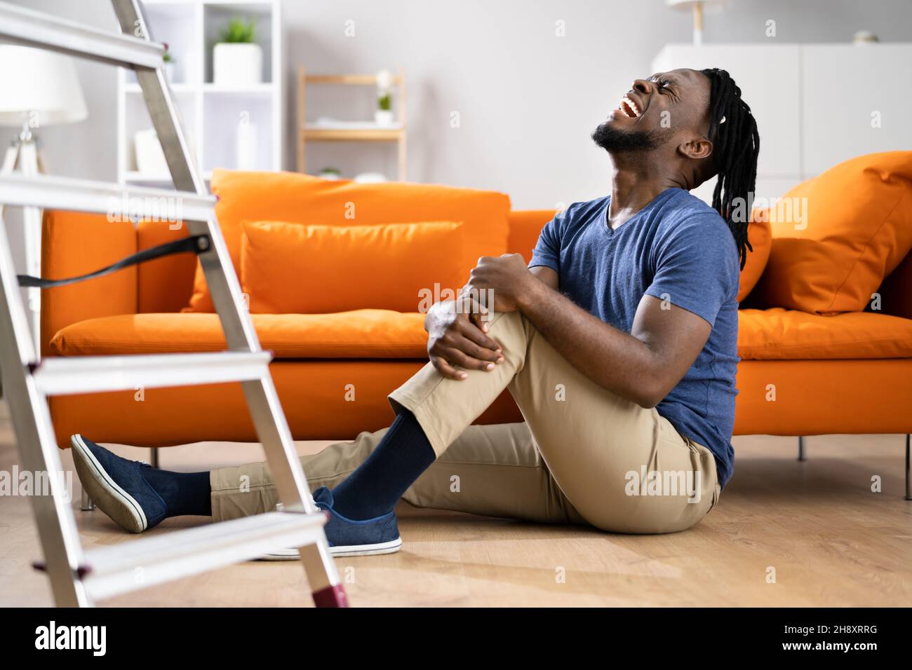 Man Falling From Ladder Accident. Safety And Injury Stock Photo
