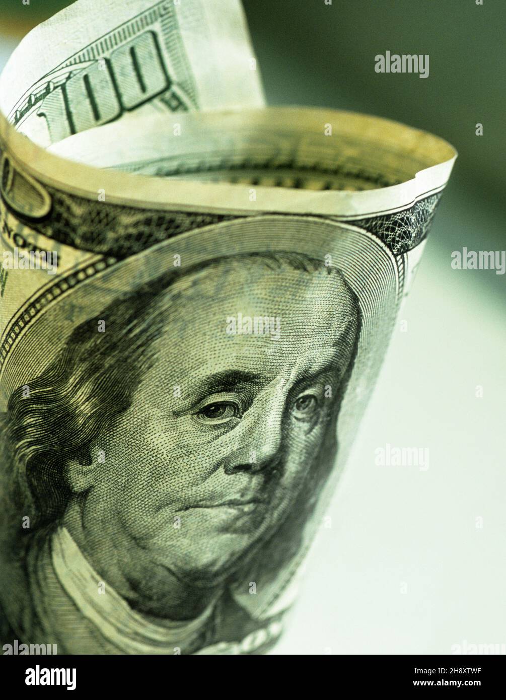 $100 dollar bill, Benjamin Franklin portrait. US banknote. Cash money. American currency. One hundred dollar bill rolled up. Copy space Stock Photo