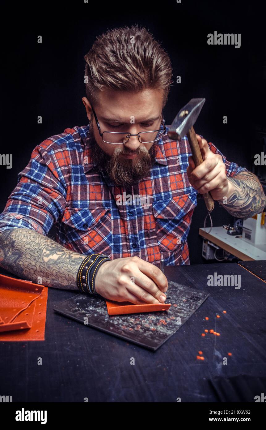 Craftsman working with leather working as artisan Stock Photo