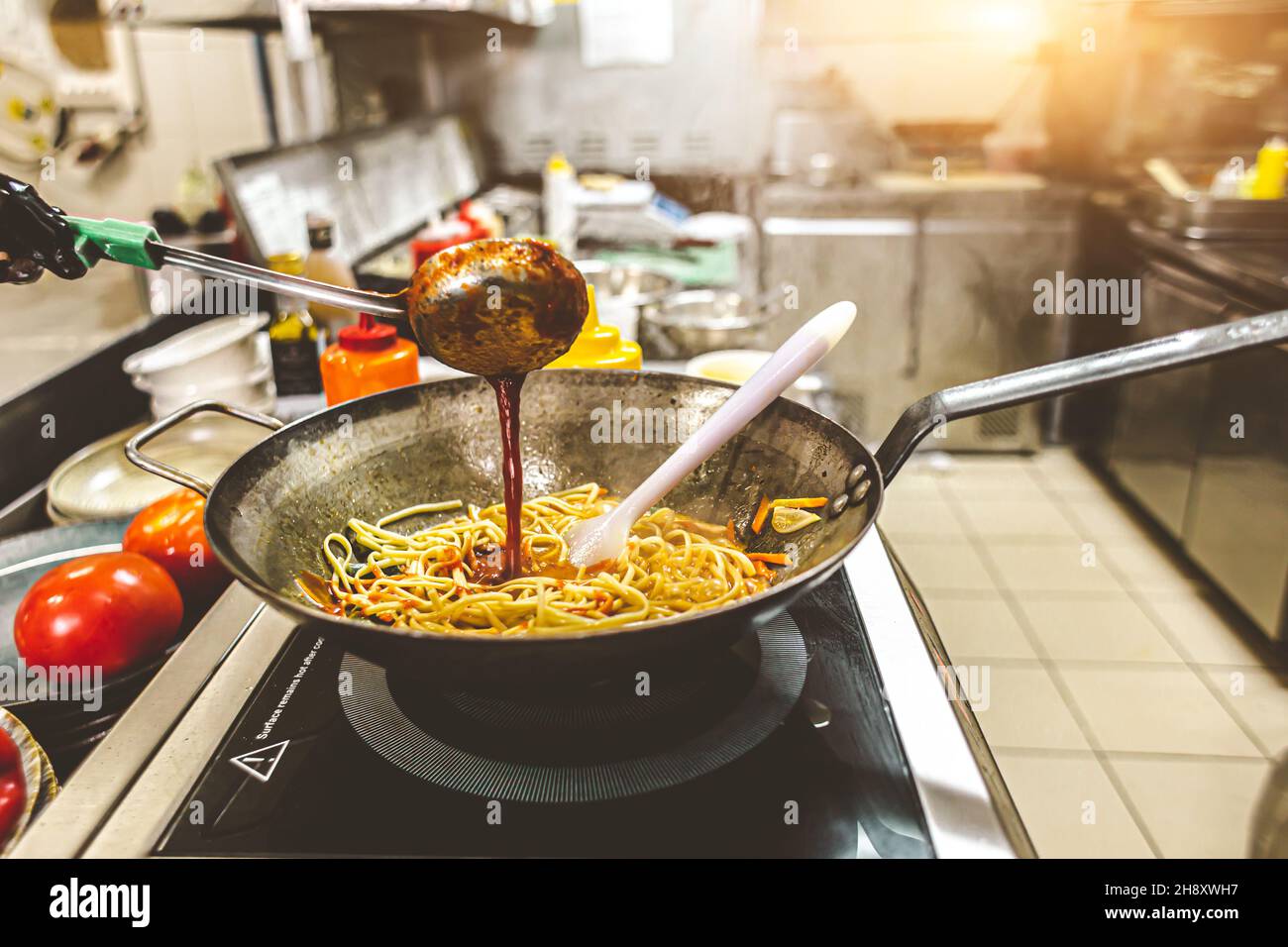 street food. fried noodles in a wok with chicken and shrimp on the wok