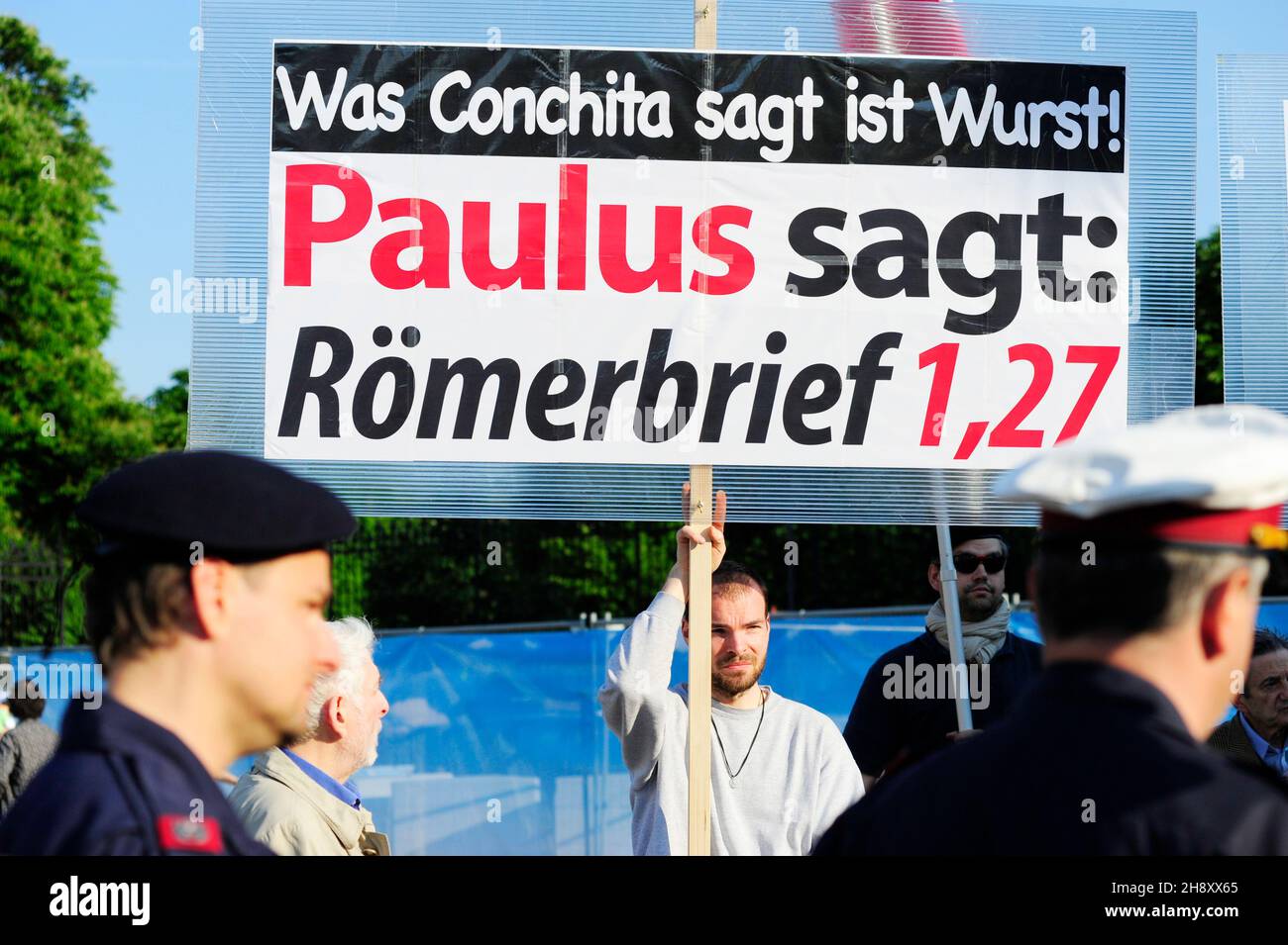 Vienna, Austria. May 16, 2015. Counter-demonstration to the Life Ball. Board with the inscription 'What Conchita says is sausage. Paul says: Romans 1.27 Stock Photo