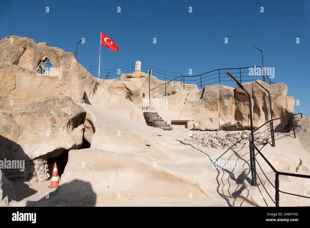 Uchisar, Turkey; November 9th 2021: Uchisar Castle flag at the top Stock Photo
