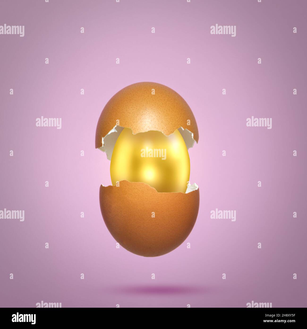 Egg shell broken into halves with a golden egg inside. Order surprise
