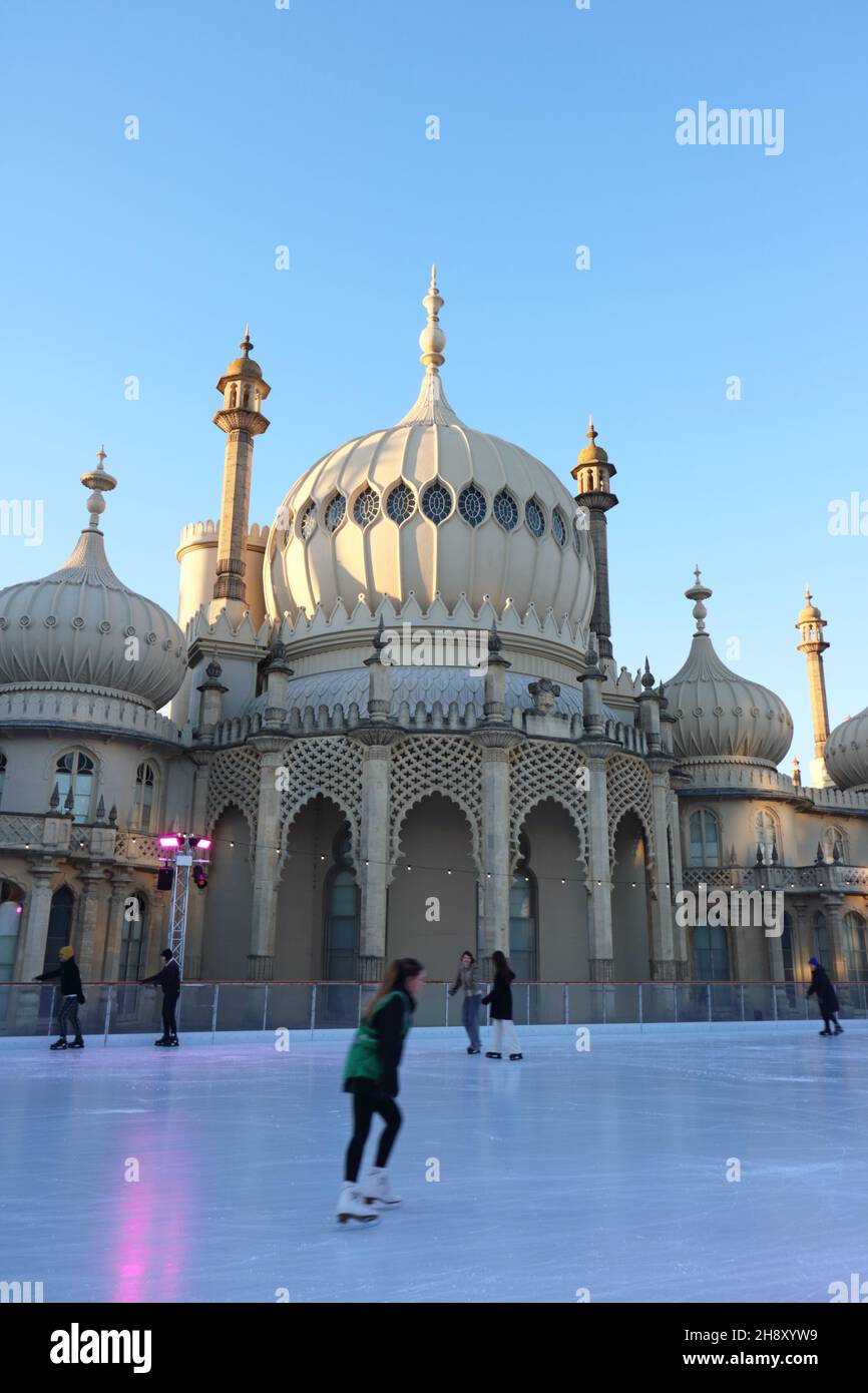 Brighton, Sussex, England, UK. 2nd Dec, 2021. The setting sun shines across the dome of Brighton Pavilion as skaters take to the ice rink on a chilly and bright winter's day, Credit: Julia Gavin/Alamy Live News Stock Photo
