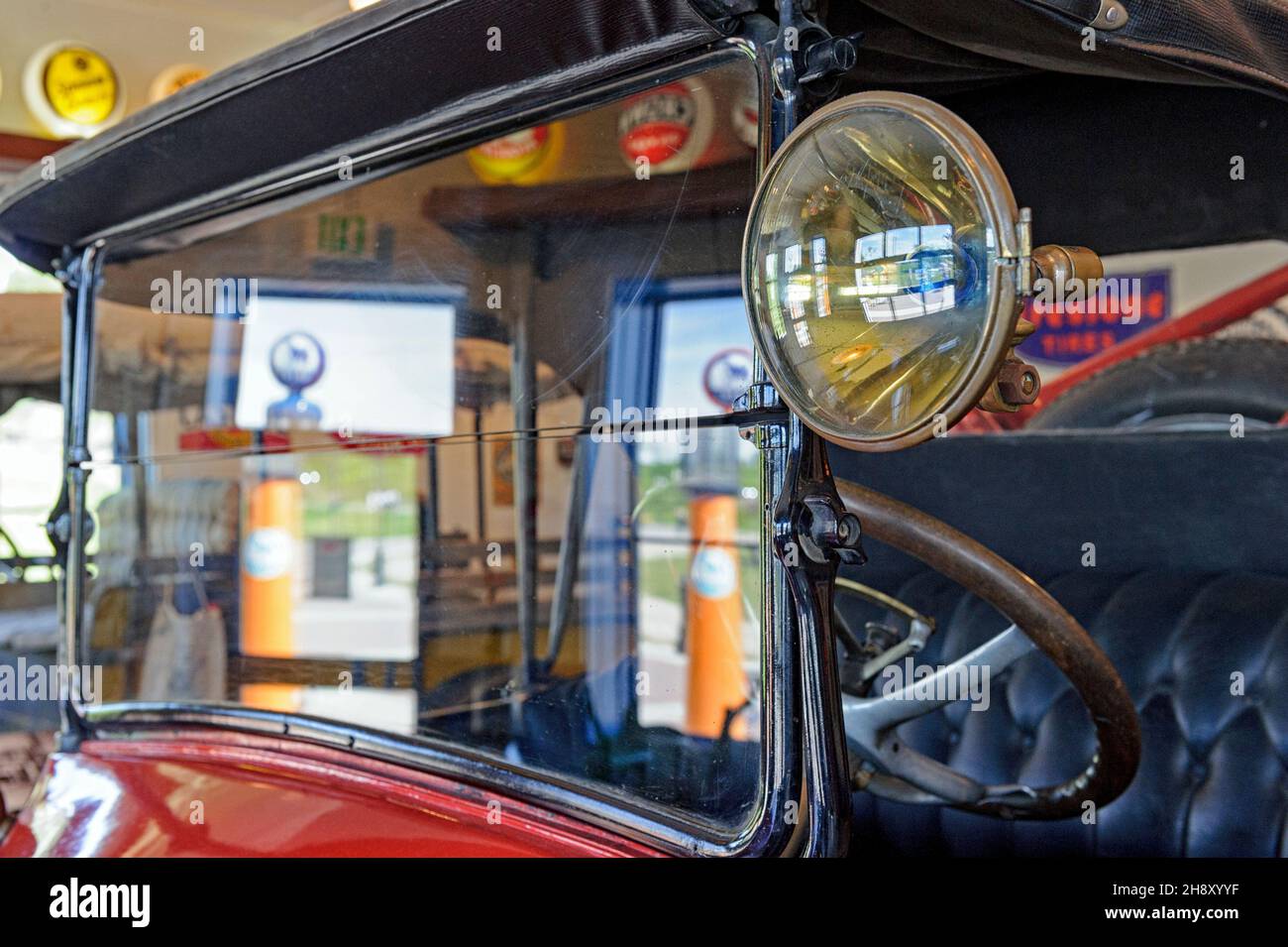A 1920s open-topped Oldsmobile antique roadster car at a service station garage Stock Photo