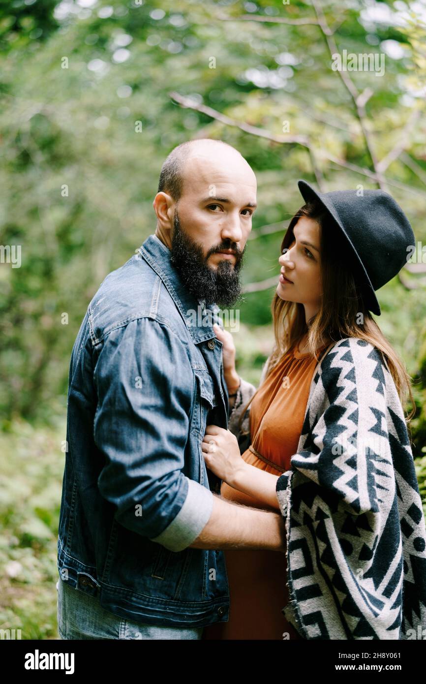 Bearded man hugs a pregnant woman in the park. Portrait Stock Photo - Alamy
