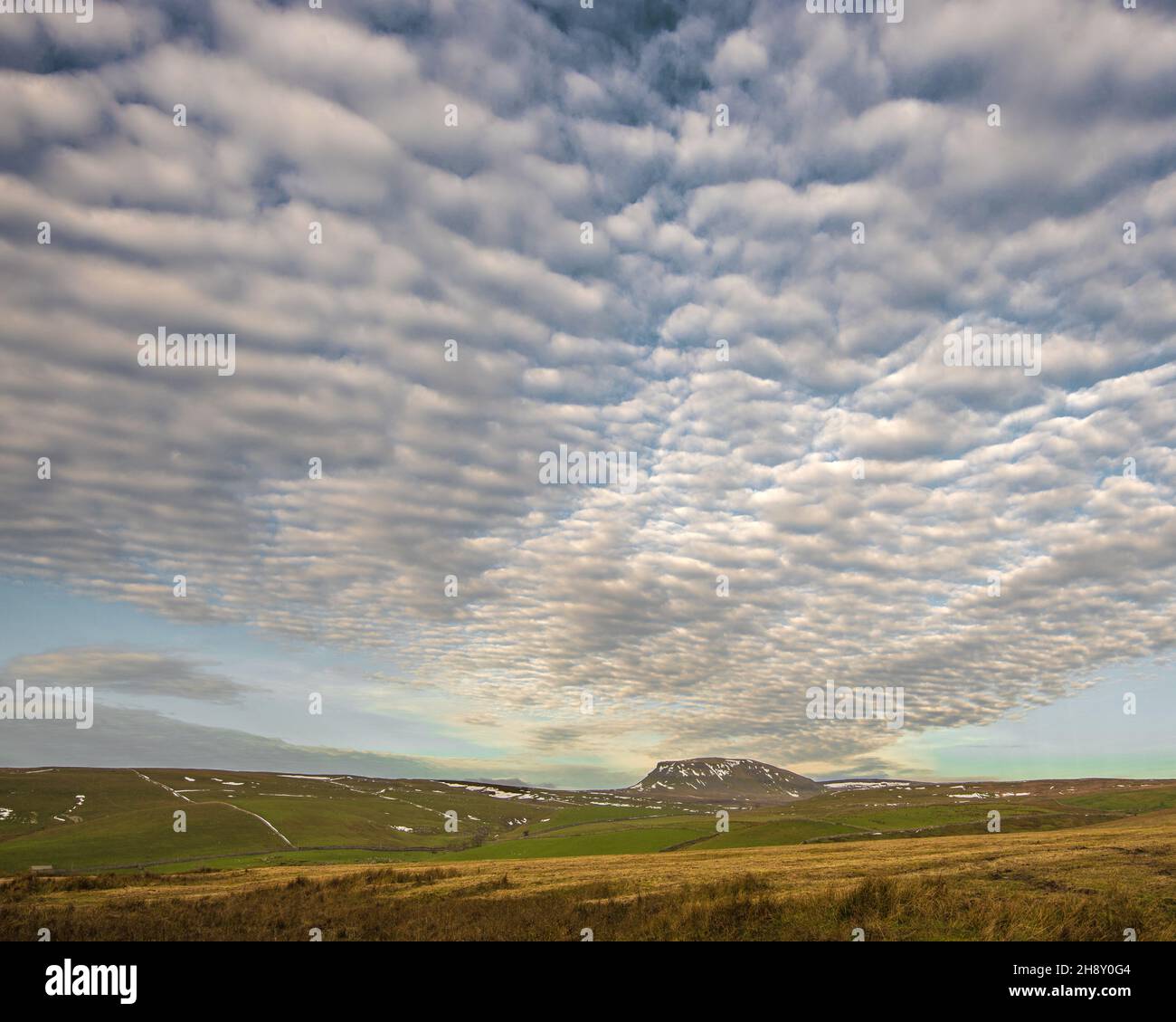 A distant Pen-y-Ghent beneath an ever-changing mackerel sky. Yorkshire Dales National Park taken(along the Yorkshire Dales Cycle Way) Stock Photo
