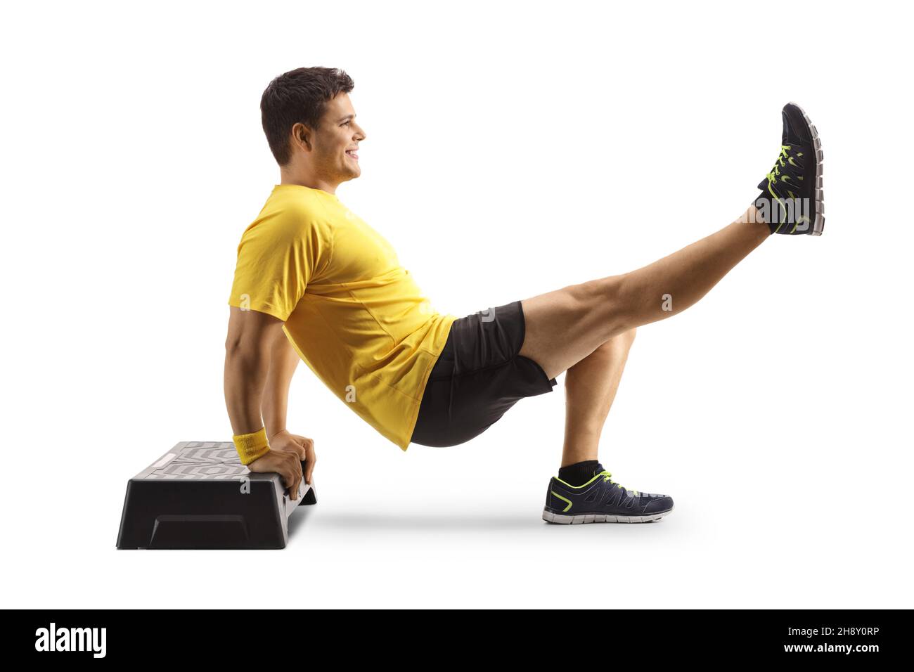 Man exercising on a step aerobic platform isolated on white background ...