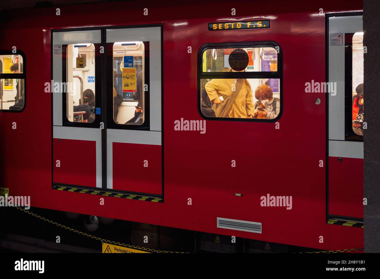 Milan, Italy people wearing covid19 masks inside metro coach. Crowd with coronavirus face