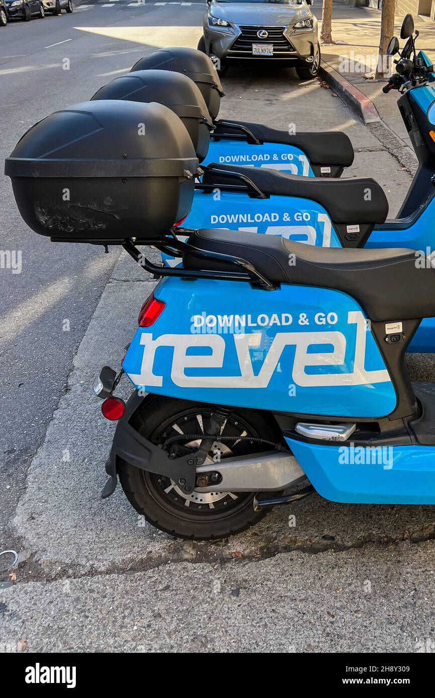 Electric Revel mopeds are parked on a street in San Francisco on Nov