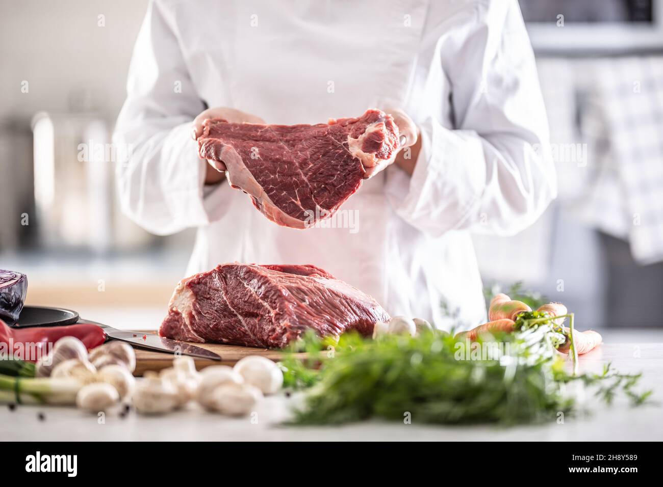 Professional chef cutting fresh meat hi-res stock photography and ...
