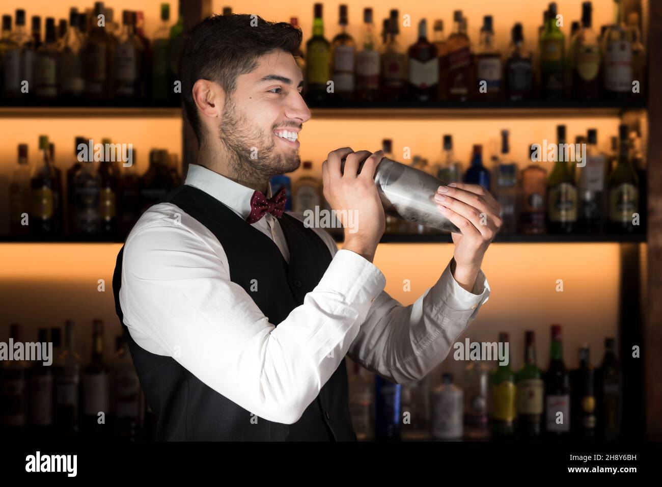 Bartender making cocktail, using cocktail shaker Stock Photo by vladans