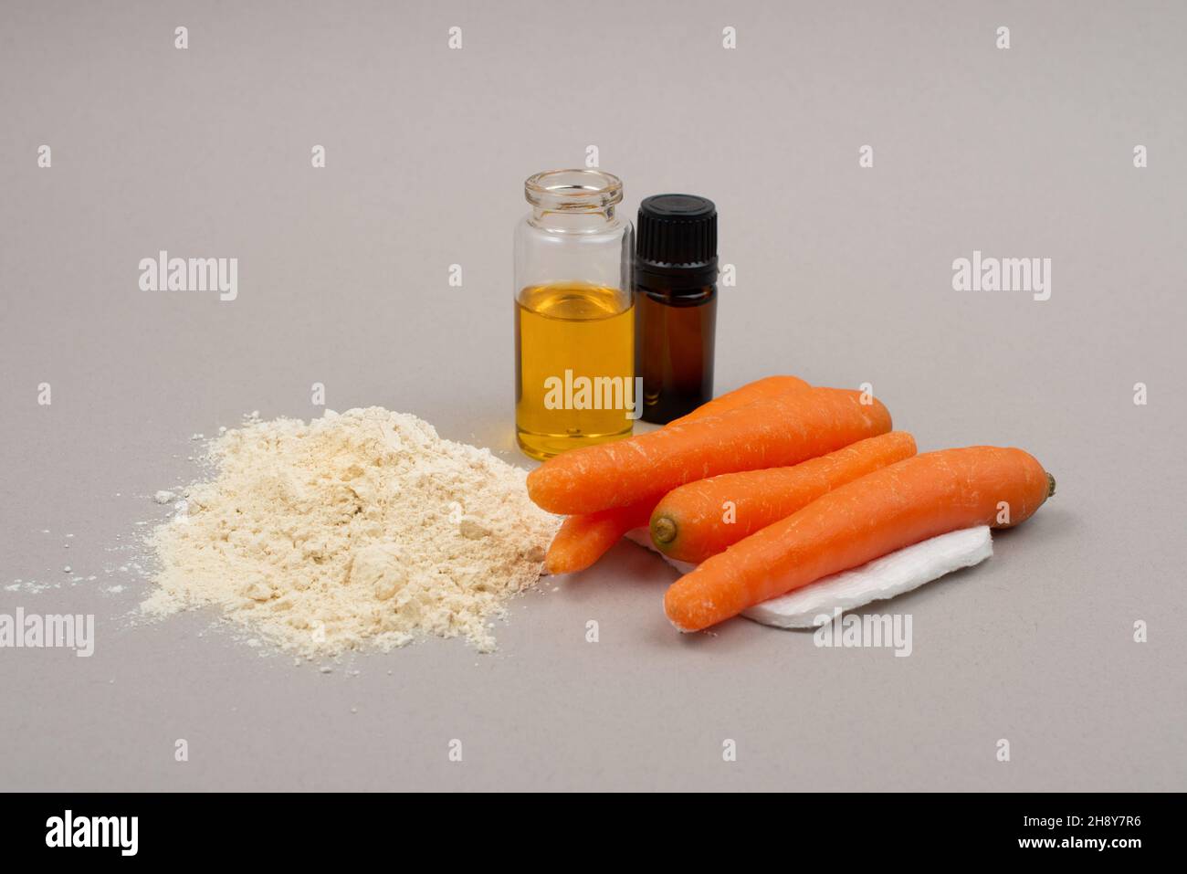 Carrot powder and carrot oil, organic home made cosmetic ingredient. Stock Photo