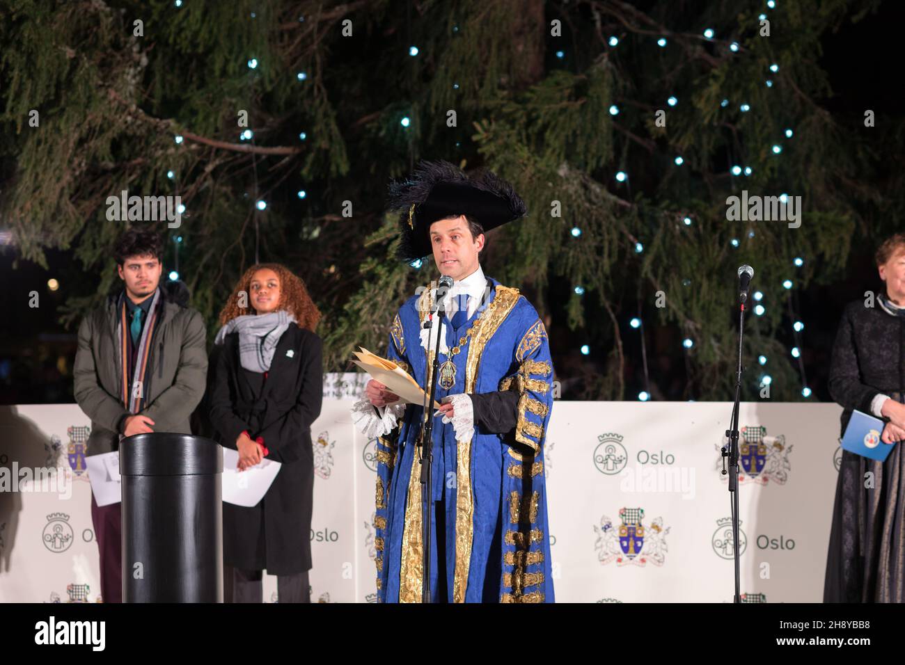 London, UK. 02nd Dec, 2021. Lord Mayor of Westminster, Councillor Andrew Smith (M), seen giving a welcome speech, during the ceremony.The annual Trafalgar Christmas Tree Ceremony has taken place since the 1947s. A giant Norwegian spruce, standing at 25 meters tall, is gifted by the people of Norway to London in recognition of Britain's support during the Second World War. The Christmas tree is lit up during the ceremony, with choirs and bands performing Christmas Carols. (Photo by Belinda Jiao/SOPA Images/Sipa USA) Credit: Sipa USA/Alamy Live News Stock Photo