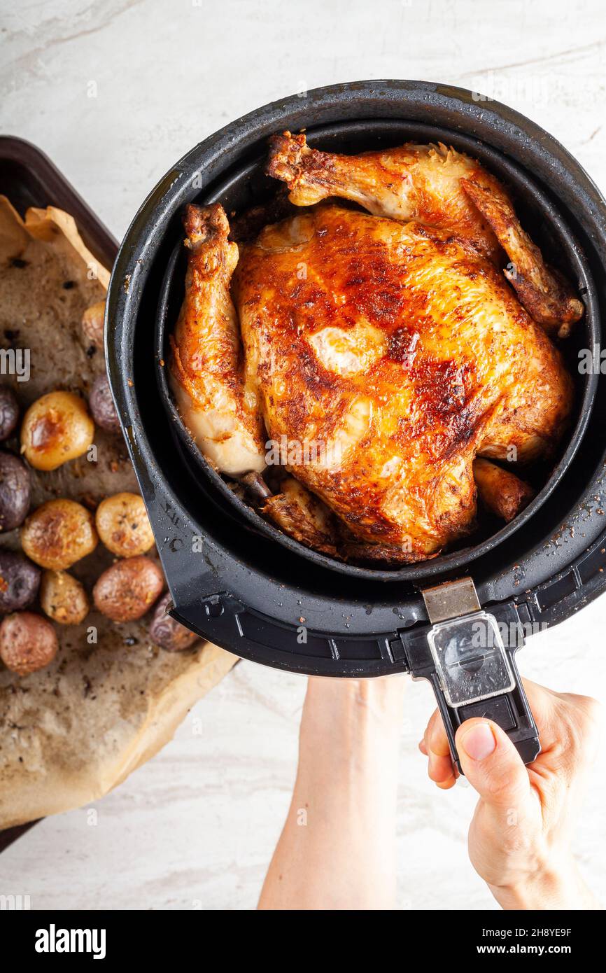 A whole chicken cooked inside an air frier concept. A healthy