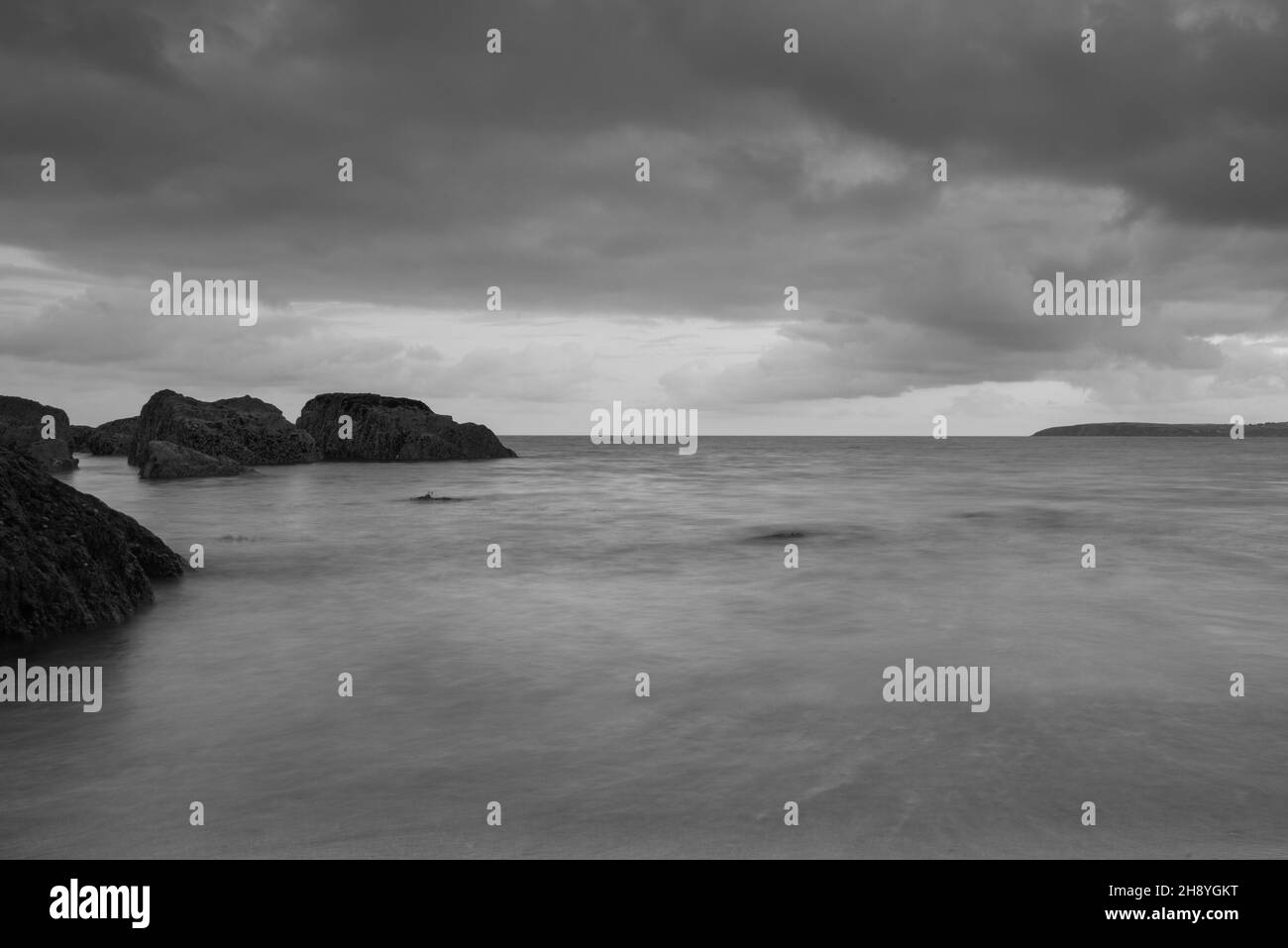Grayscale shot of a coast on a foggy day Stock Photo - Alamy