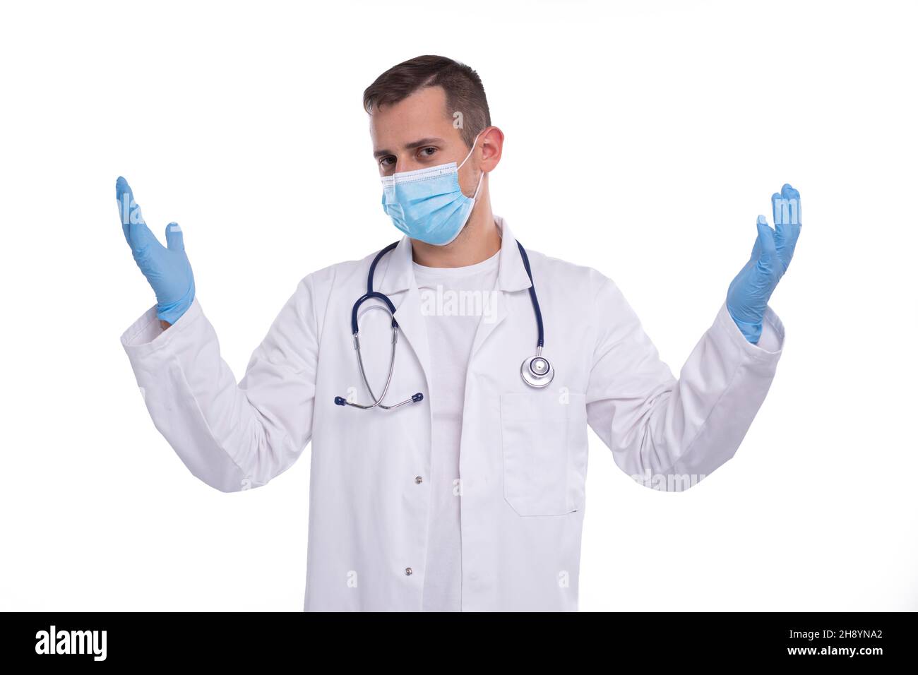 Doctor Wearing Medical Mask and Gloves Holding Hands to Sides Isolated Stock Photo