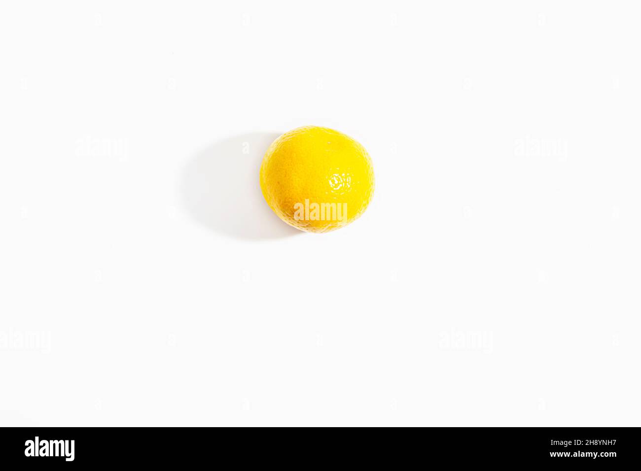One whole tangerine on a white background. New Year and Christmas symbol. Isolate. Lifestyle. Close-up. View from above. Horizontal photo. High quality photo Stock Photo